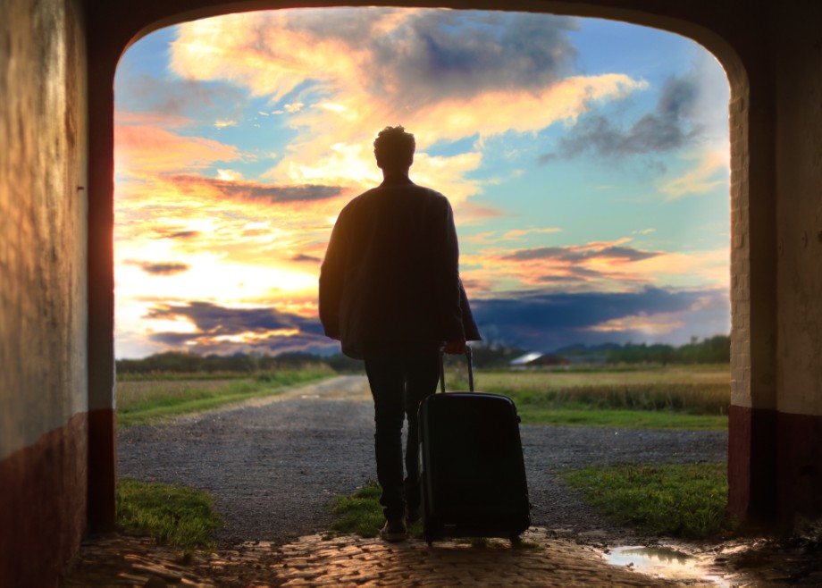 Man walking into clouds on the horizon